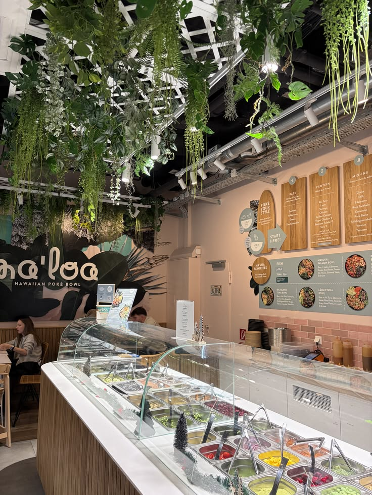 Modern build-your-own bowl counter with fresh toppings behind a glass display