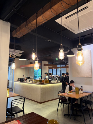 Interior of Strangers at 47 with service counter, warm pendant lights, and diners