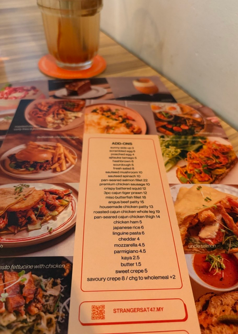 Strangers at 47 add-ons menu with eggs, patties, salmon, and extra toppings